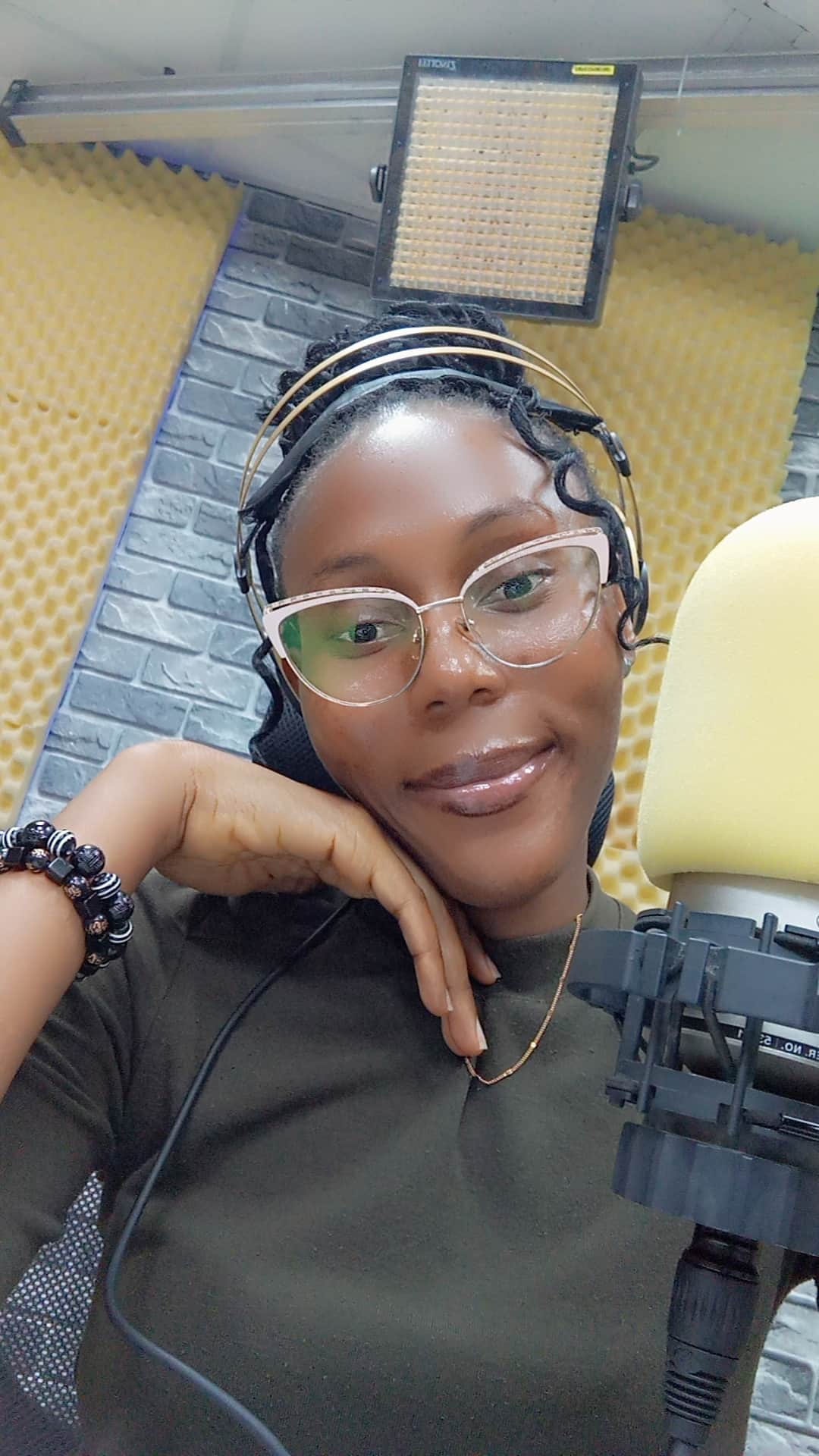 Dorcas Koki close up wearing a headset at the mic